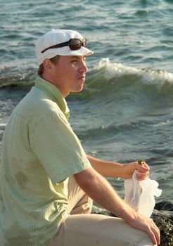Young man with a bottle in profile of water