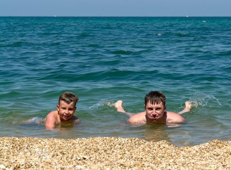 summer days. father and the son on the beach.