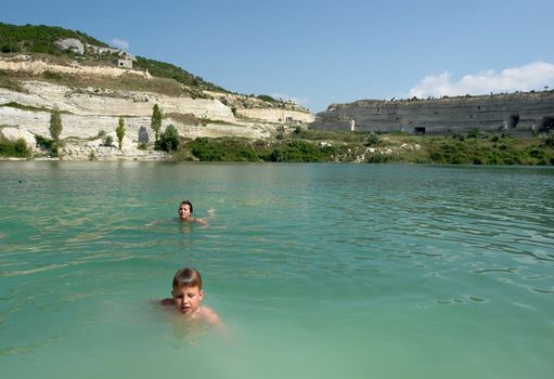 Mother and the son in mountain lake