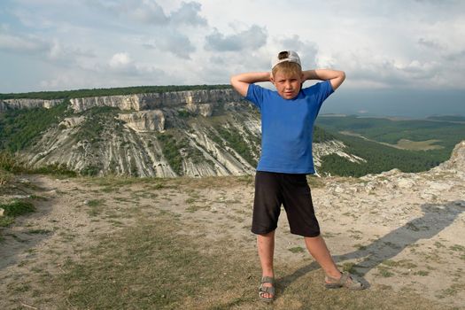 The little boy against a mountain valley