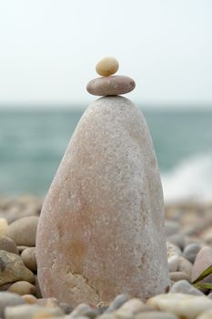 Summer Days. Stone pyramid on a solar beach.