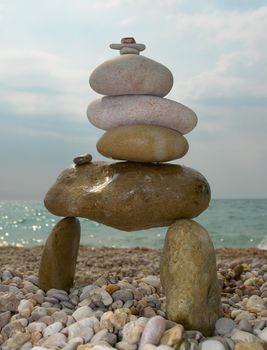 Summer Days. Stone pyramid on a solar beach.