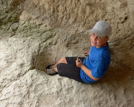little boy in an ancient mountain cave