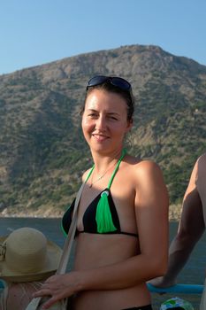 The beautiful smiling girl against high mountain