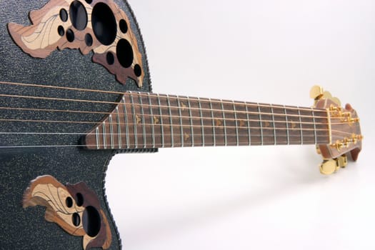 perspective view of black guitar and strings music equipment on white background
