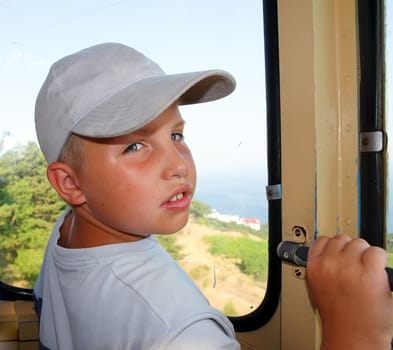 Portrait of the little boy near a window