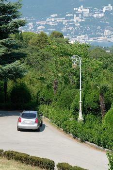 car and lantern in the foreground. Yalta city. the panoramic view on top.