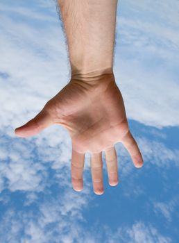 Human hand on a blue sky
