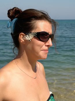 Portrait of the young woman against the sea