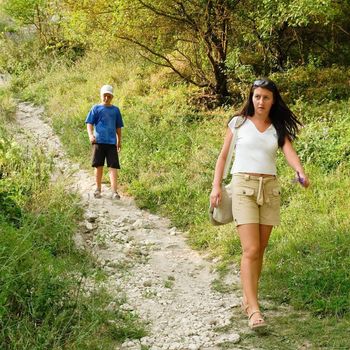 Mum and the son go down on a mountain footpath