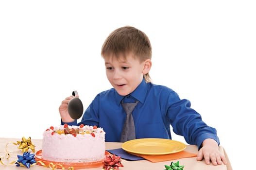 child with a large spoon is going to eat cake isolated on white background