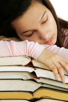 tired caucasian teenage girl portrait sleeping on books stack