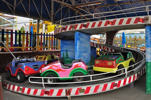 Car rides in empty amusement park on a cold day.