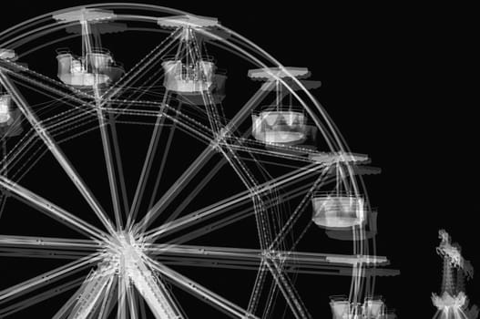 Ferris wheel carousel horse in amusement park. Black and white solarisation effect.