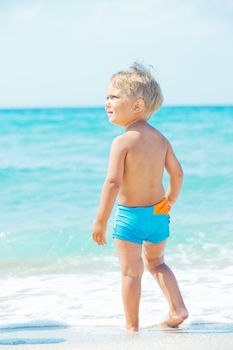 A cute little boy having fun on the exotic beach