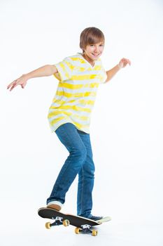 cute teenger blond boy on standing on skateboard isolated on white background