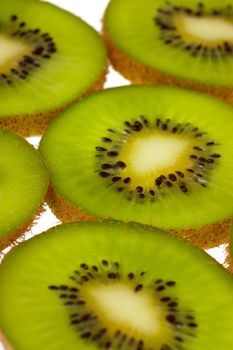 Close-up view of kiwi slices over white background