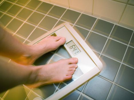 Womans feet on weight scale