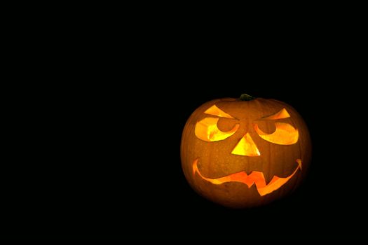 ghastly halloween pumpkin on black background