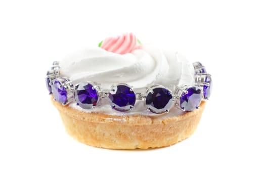 cupcake and bijouterie bracelet on a white background