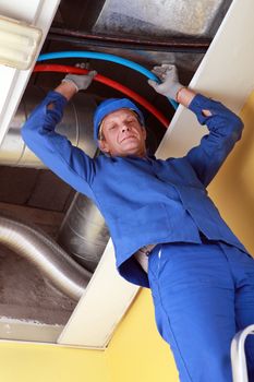 Plumber standing on ladder