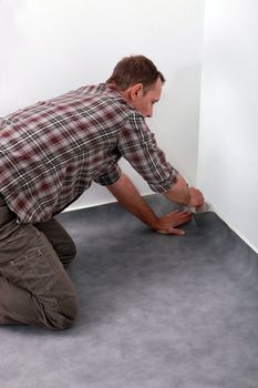 Man laying carpet