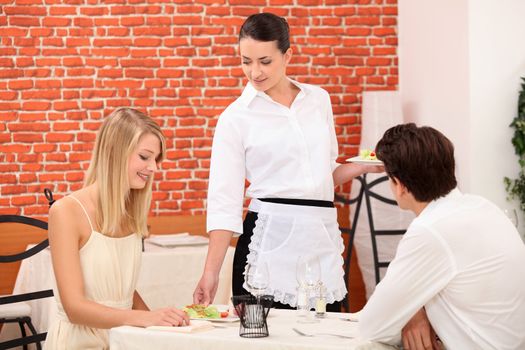 couple and waitress at restaurant