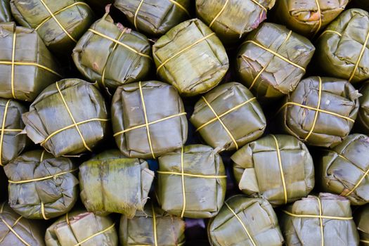 Sour pork : Thai northeastern style food which mixed pork rice garlic sugar and salt in banana leaf package