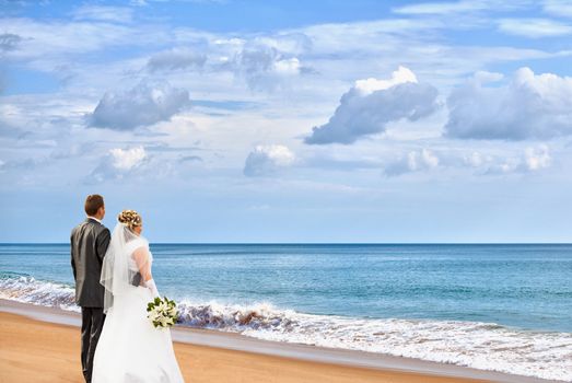 The bride and groom on an ocean coast