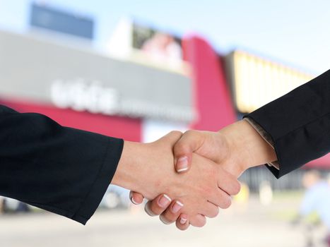 Handshake Handshaking and blured building in background
