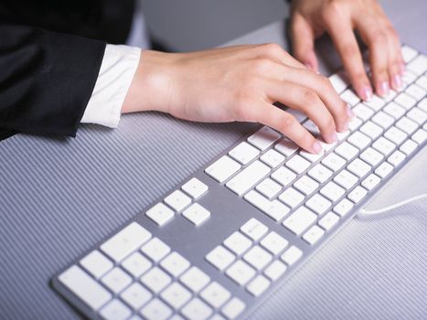 Business Secretary Typing on Computer Keyboard