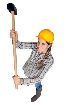 A female construction worker holding a sledgehammer.