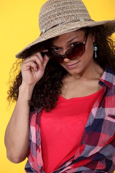 Woman wearing sunglasses and straw hat