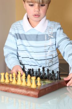 Little boy playing chess