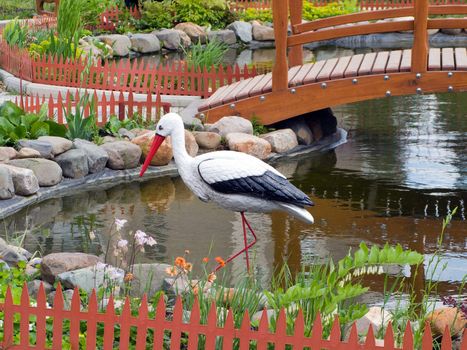 Beauty pond with bridge at park and bird in water