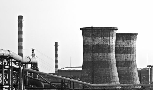 Black & White landscape photo of factory with giant chimneys