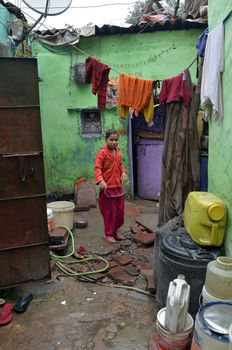 New Delhi,India-February 4, 2013:An unidentified child in the courtyard of his house in the slum on February 4,2013 in New Delhi. 17 million residents do not have access to city water