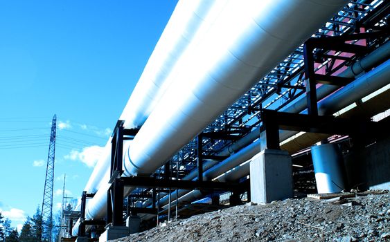 industrial pipelines with insulation against natural blue background