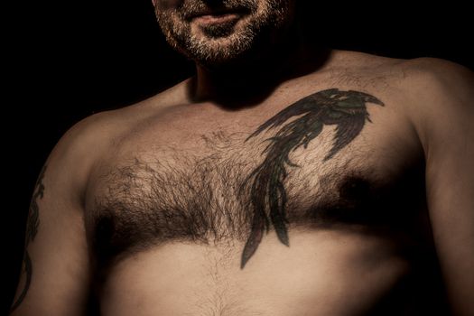 An image of a handsome man with a tattoo