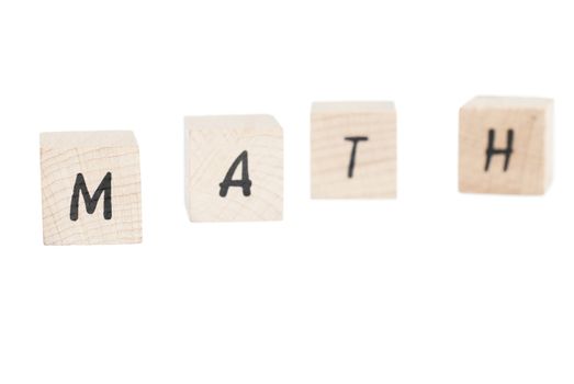 Math written with wooden blocks. White background.