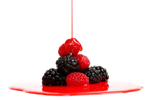 berry mixed pile in syrup isolated on white