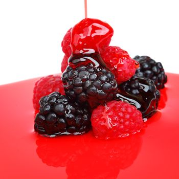 berry mixed pile in syrup isolated on white