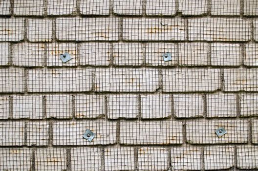 white brick wall with metal wire net attached prepared for renovation background closeup.