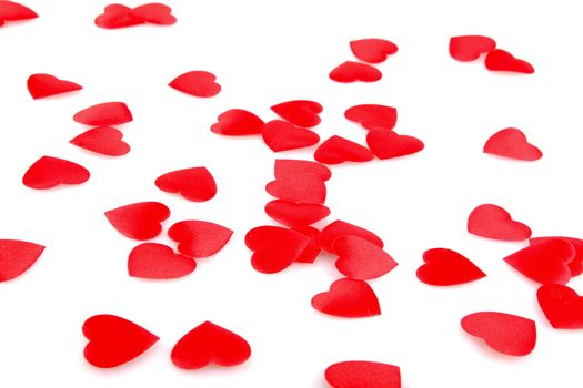 Red hearts confetti on white background