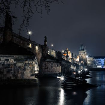 Charles bridge in Prague with lanterns at night