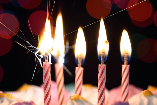 Some lit birthday candles close up 