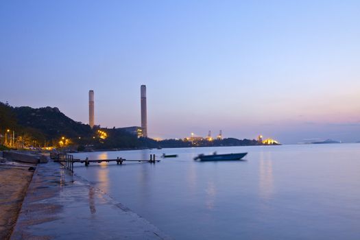 Power plant along the coast at sunset time