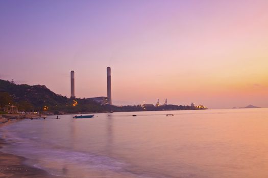 Power plant along the coast at sunset time