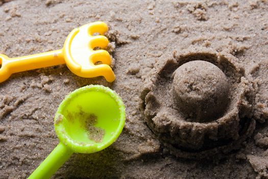 Plastic sandbox child toy on summer beach sand