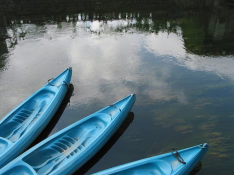 Three blue canoes for hire in a French river